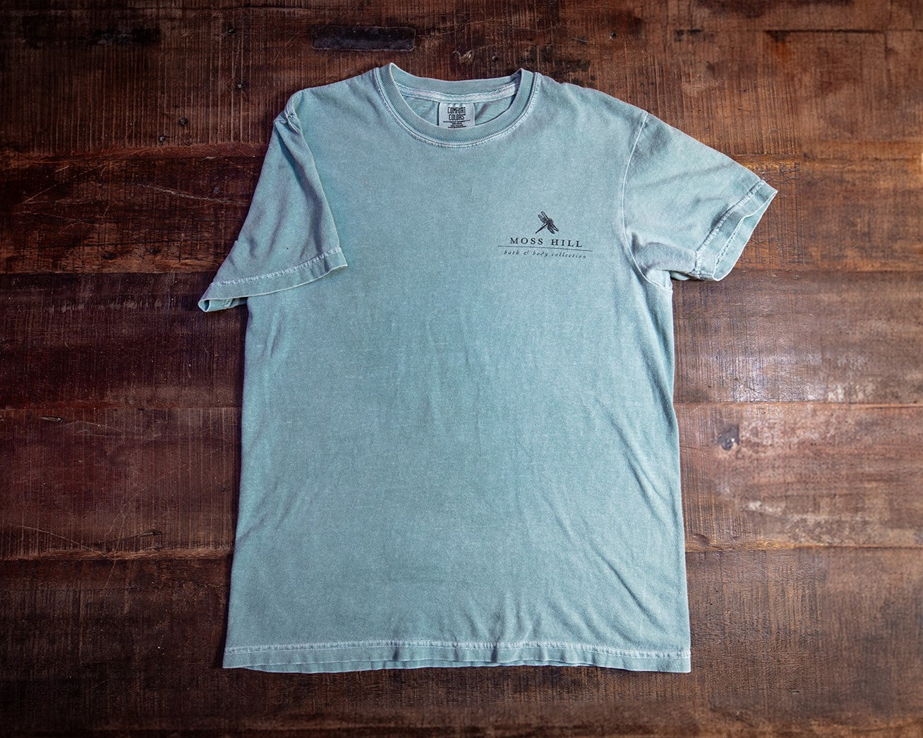 Blue comfort colors t-shirt with the Moss Hill Logo on the right chest