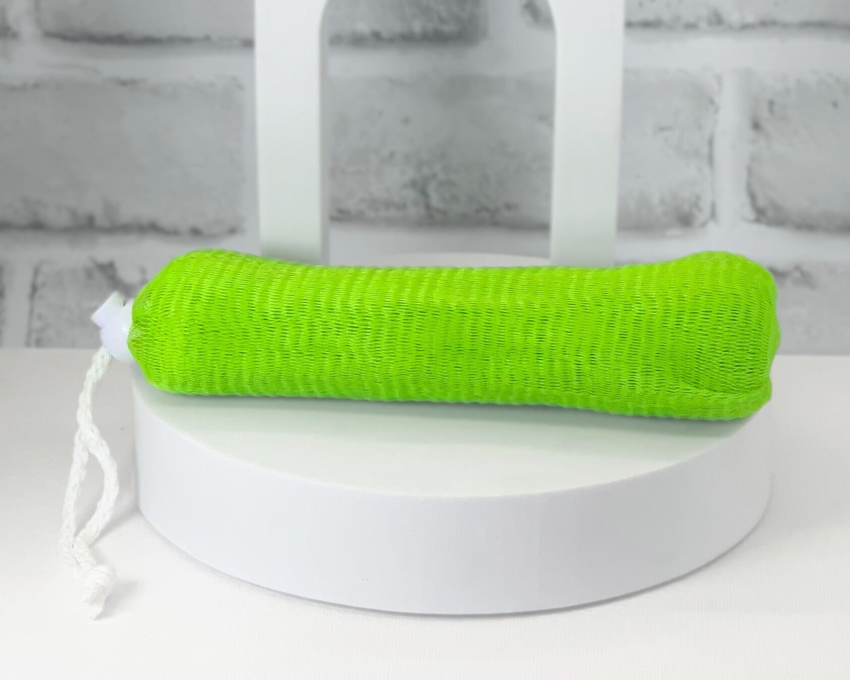 Colorful mesh loofah pouch used as soap saver in bathroom