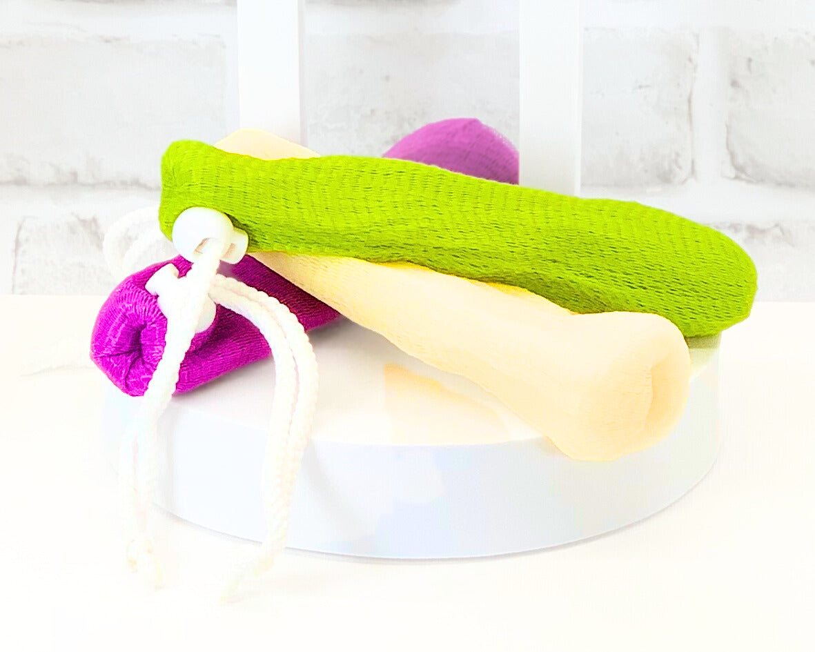 Shower loofah pouch for bar soap in tan, green, pink, and yellow