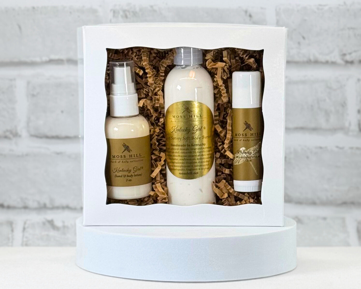 Three piece body gift set with 2 oz lotion, 4 ox body butter, and a moisturizing stick. All in the scent Kentucky girl wrapped in a white box with brown filler paper.