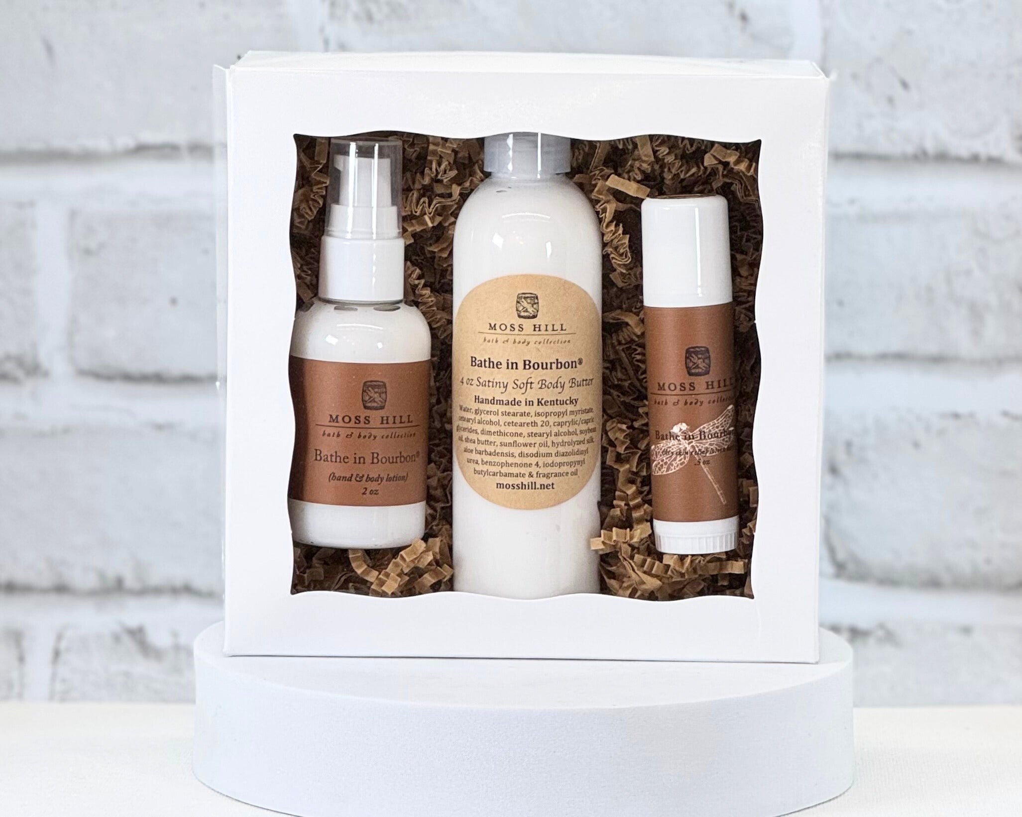 Three piece body care gift set in the scent Bathe in Bourbon. It comes with a hand and body lotion, body butter, and dry skin relief stick.