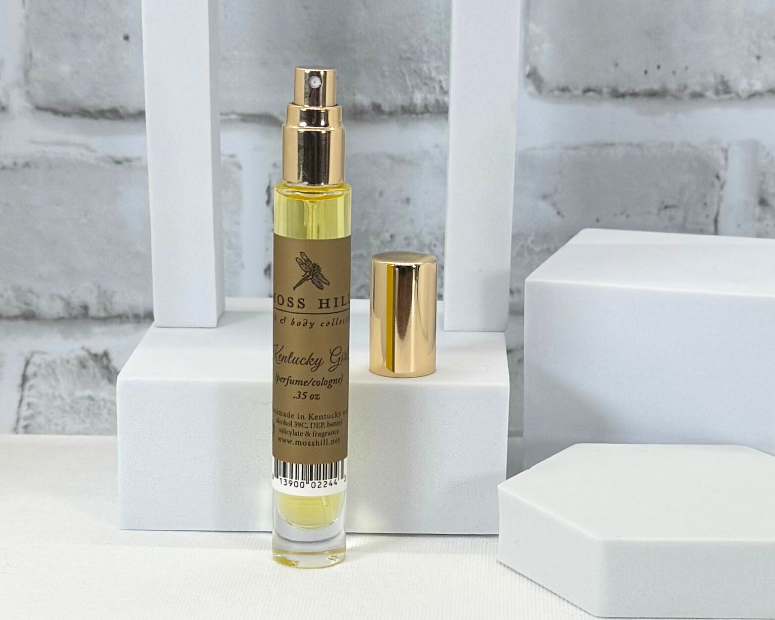 Travel size Moss Hill perfume spritzer in Kentucky Girl scent displayed on a styled background. handmade in Louisville, KY.