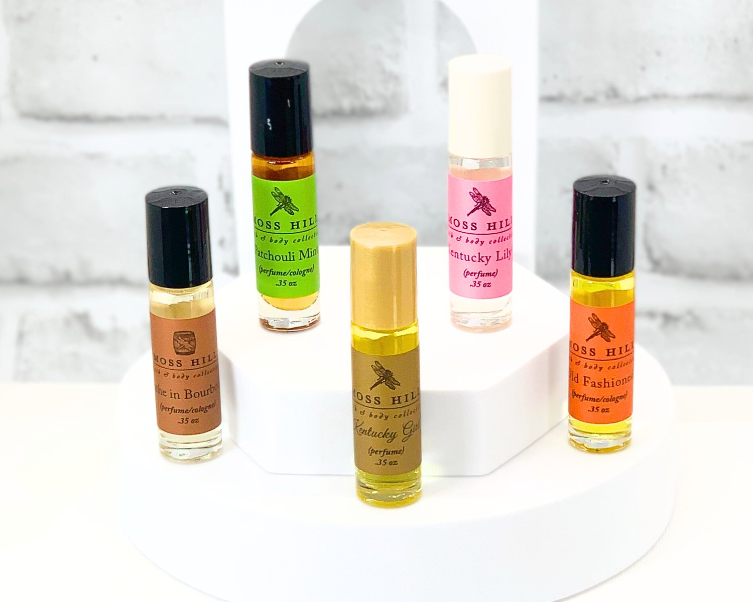 A collection of travel-sized roll-on perfume bottles in various colors and fragrances.