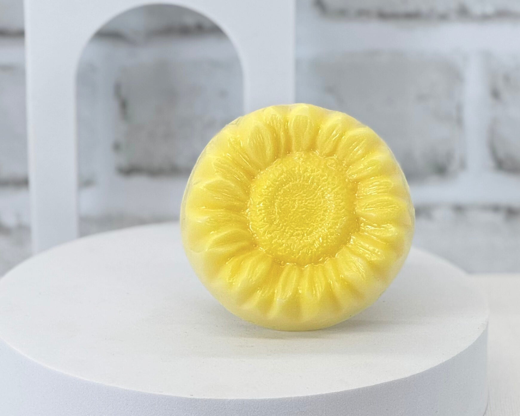 A yellow sunflower shaped soap. Handmade in Louisville, KY by Moss Hill Bath & Body Collection.