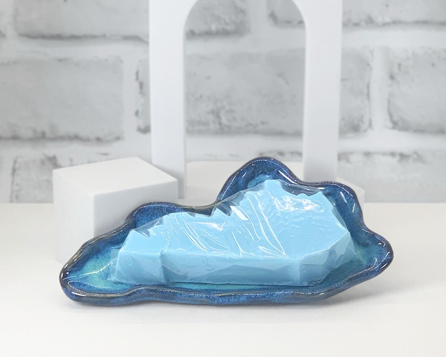 Blue custom made soap dish for high quality handmade soaps in the shape of Kentucky with a soap bar.
