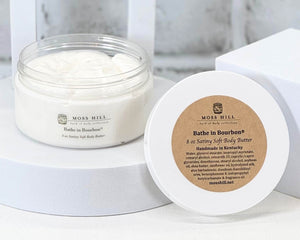 Moss Hill body butter jar and container on a white background. In the scent Bathe in Bourbon.