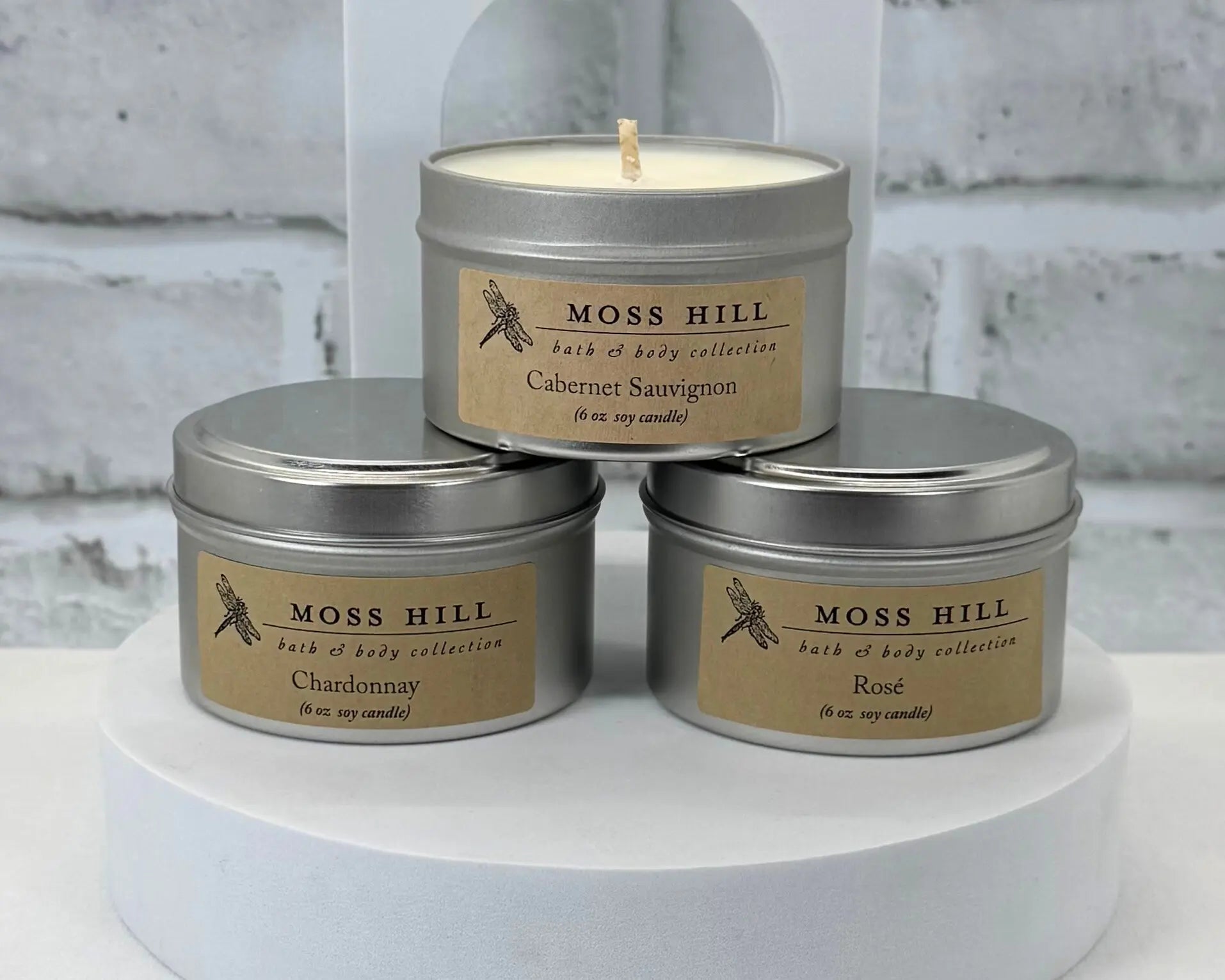 Three soy candles with wine themed scents. Hand-poured into silver tins stacked on-top of each other.