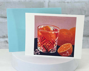 Greeting card with a cocktail illustration on Old Fashioned on a white surface. Which represents the Old Fashioned scent profile for handmade bath and body products.