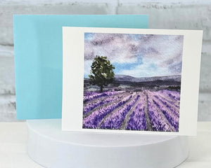 Greeting card with lavender field design on a white stand. Representing the Lavender scented handmade bath at body product at Moss Hill Bath and Body.