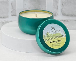 An 8 oz soy candle, hand-poured into a teal container, styled on a white surface with a white background.