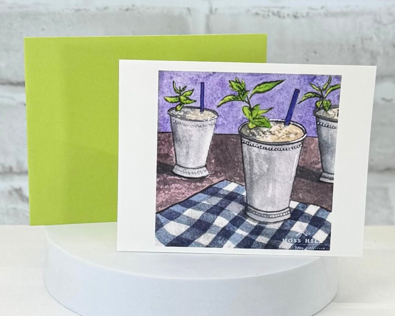 Greeting card with illustration of mint juleps on a checkered tablecloth, green envelope. This represent our Mint Julep scent collection.