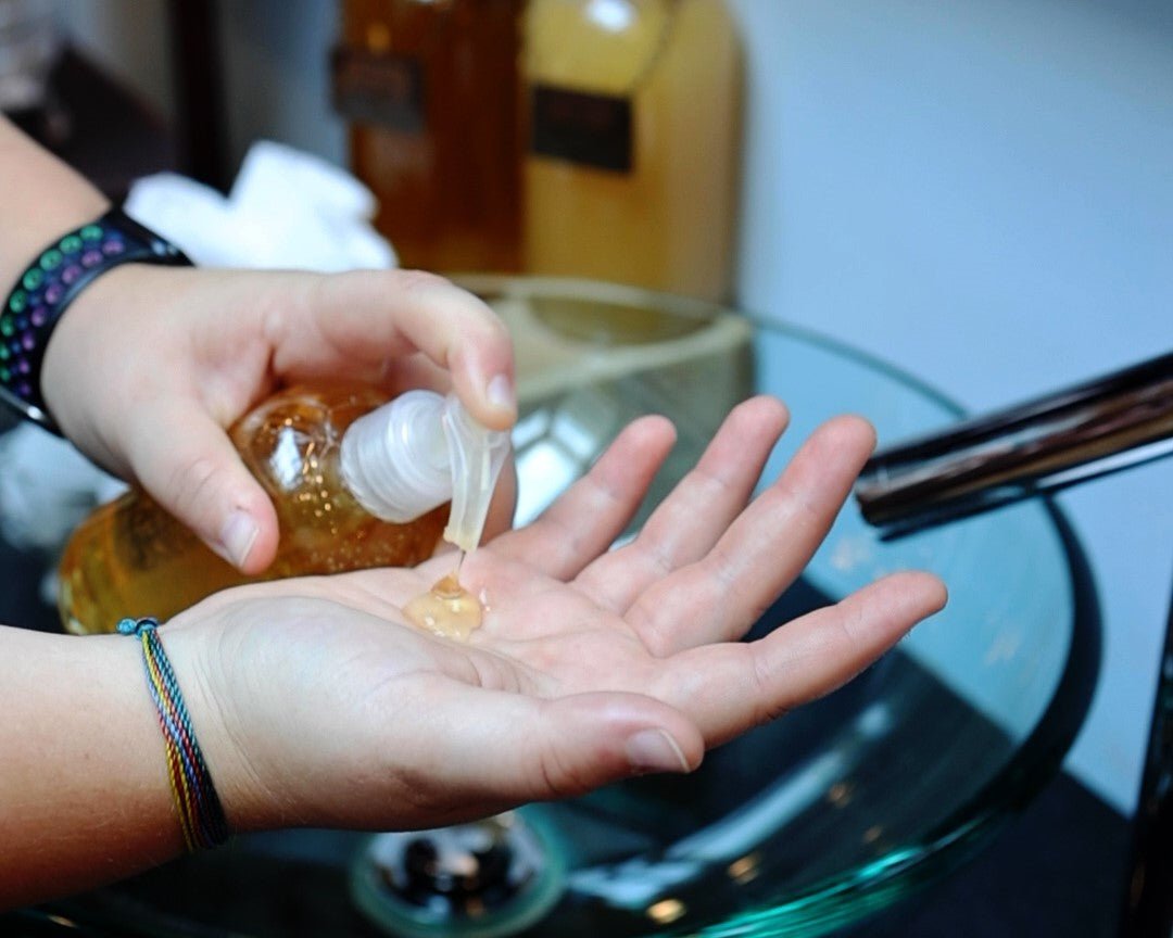 Moss Hill hand and body wash being pumped from a clear bottle into a hand.