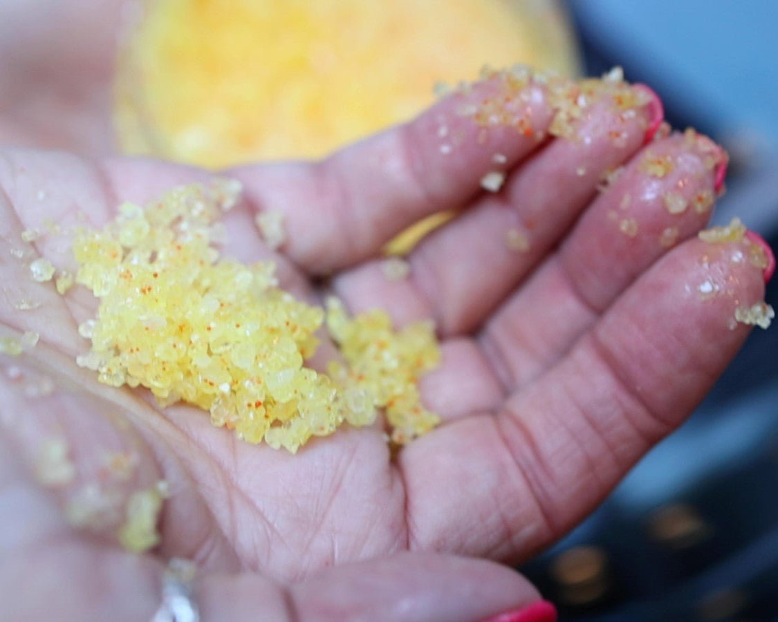 One hand with homemade sea salt body scrub in the palm.