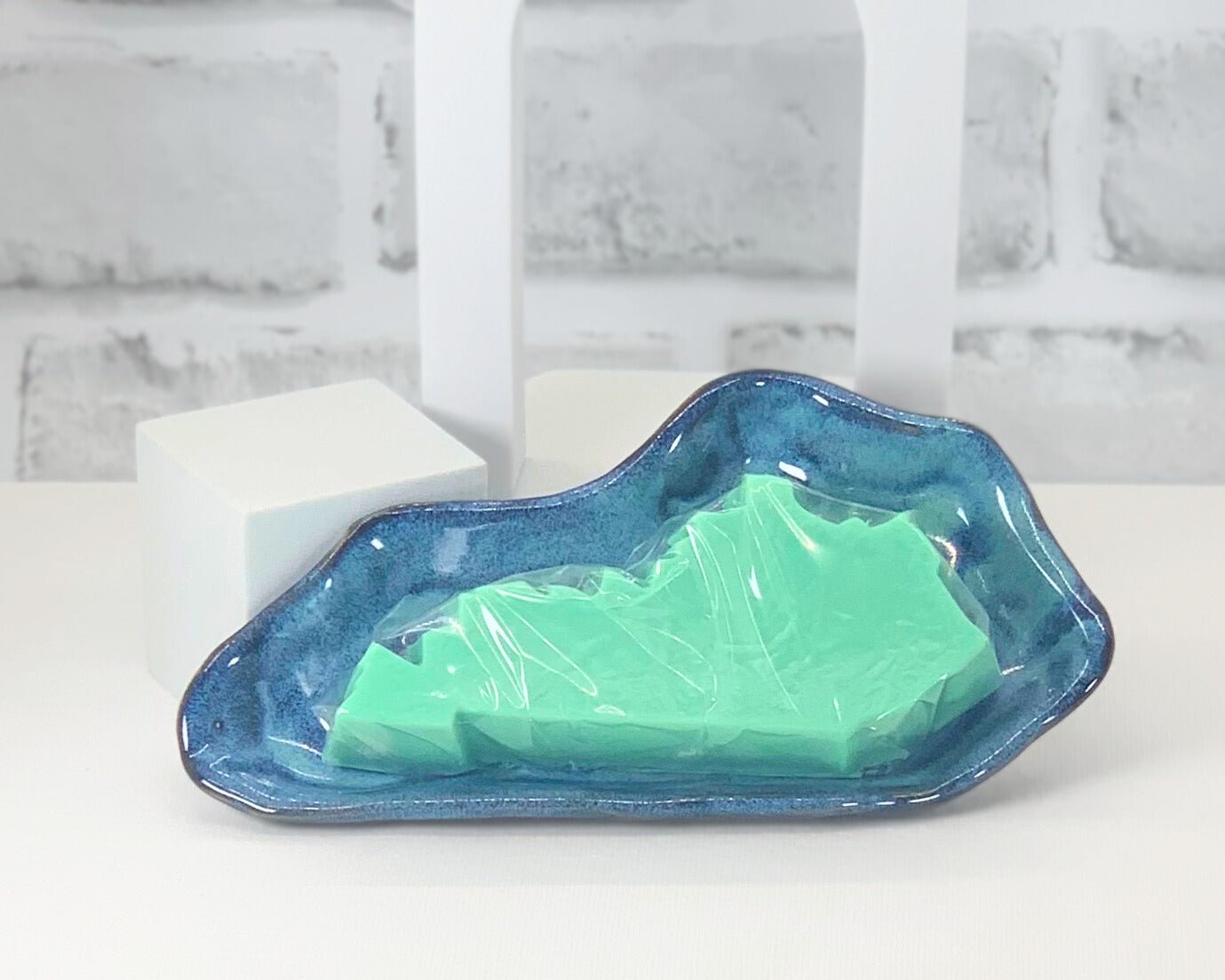 Light blue and green custom made soap dish for high quality handmade soaps in the shape of Kentucky.