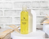 Bottle of 'Sunshine' by MOSS HILL on a white surface with a light background