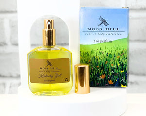 Kentucky Girl glass perfume bottle displayed on a vanity with Moss Hill branding