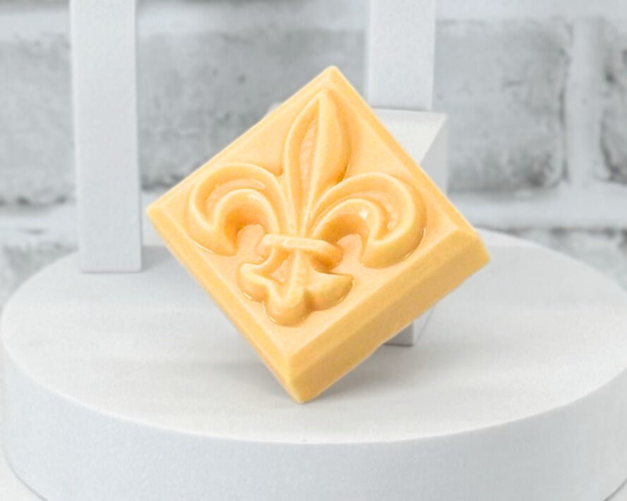 Orange bar soap shaped as a Fleur De Lis in the scent Old Fashioned