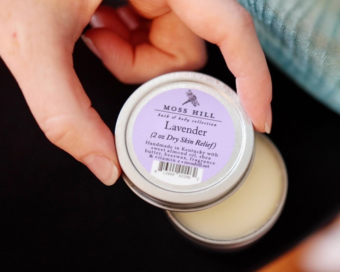 A silver lid with slightly removed from a 2 oz tin of dry skin relief balm