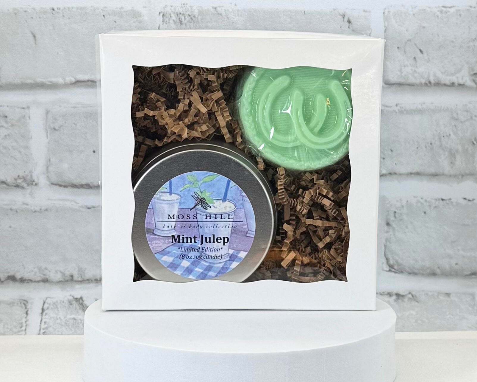 Two piece body care gift set in the scent Mint Julep. This gift set is wrapped in white box with a handmade soap with horseshoes on top with a 8 oz soy candle.