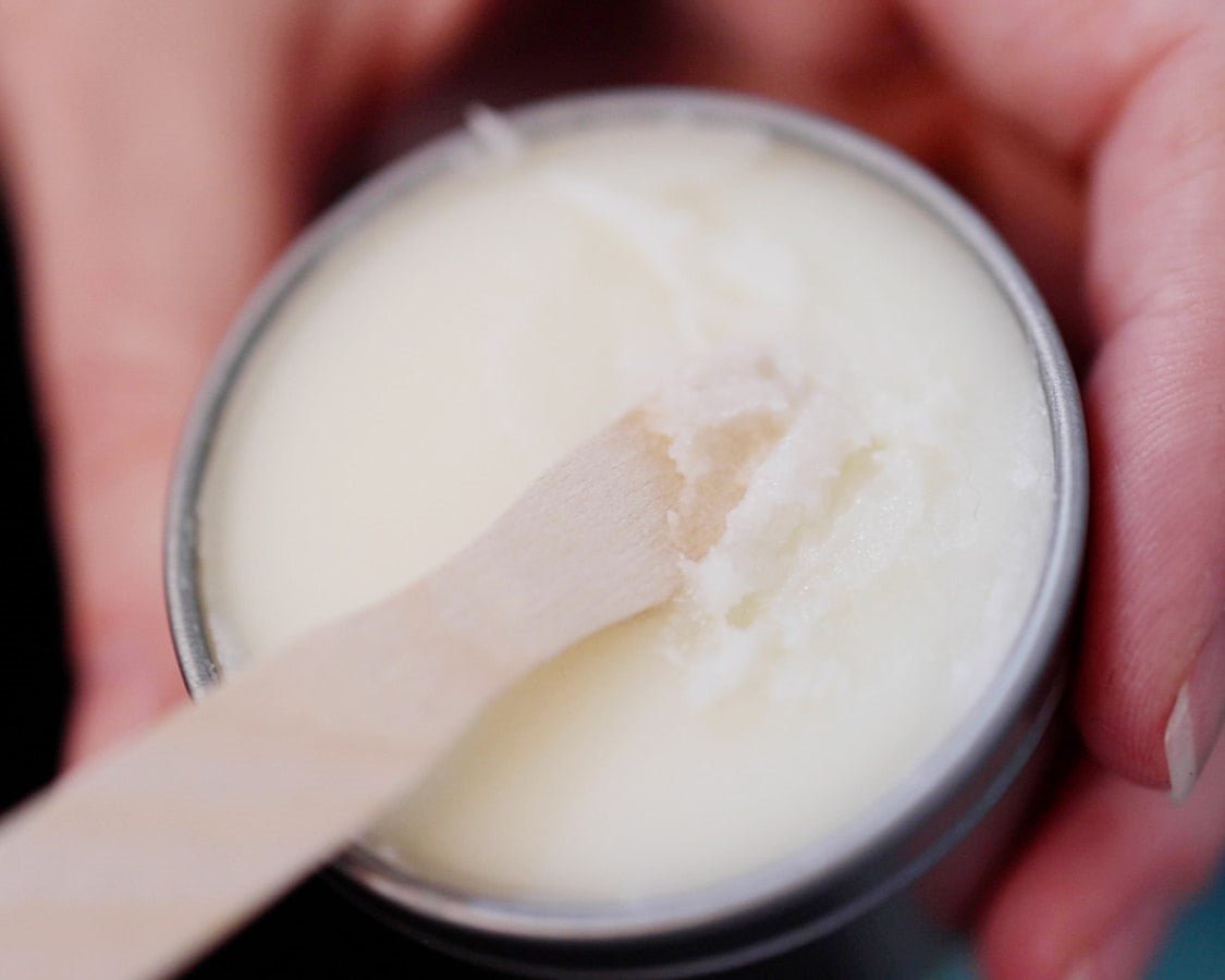 A wooden spoon scooping out Lavender dry skin relieve balm. Handmade in Louisville, Kentucky.